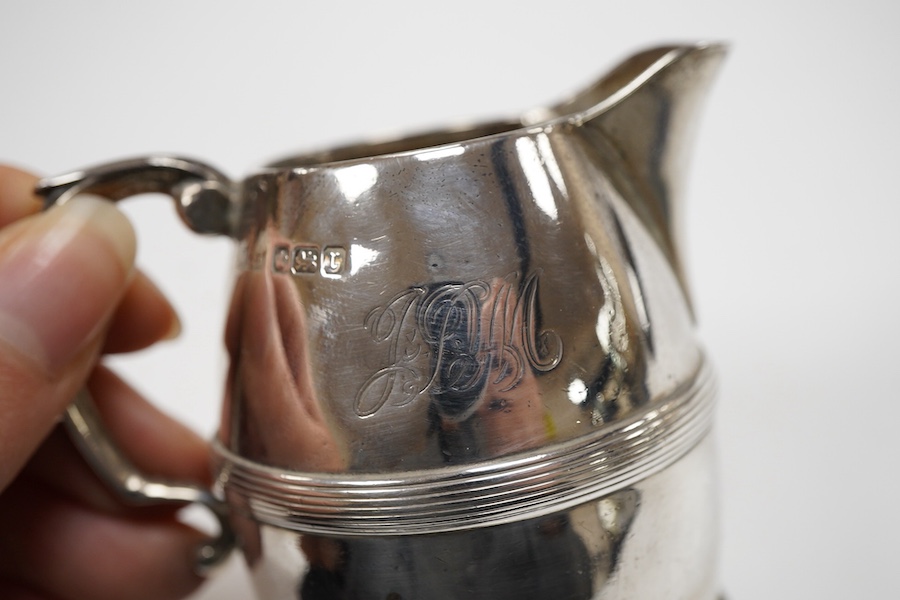 An Edwardian silver three piece bachelor's tea set, with reeded band, by Henry Stratford Ltd, Sheffield, 1909, gross weight 19oz.